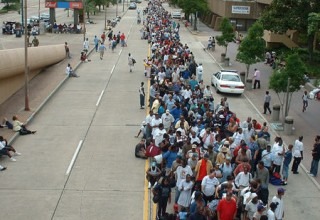 Most New Orleans residents evacuated the city before Hurricane Katrina hit in August 2005. Here, some of the survivors who stayed behind, line up to get into the Louisiana Superdome, a designated emergency shelter. (Marty Bahamonde, FEMA, on Wikipedia)