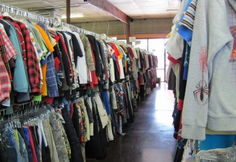 Racks of waiting clothes in A Precious Child's warehouse.