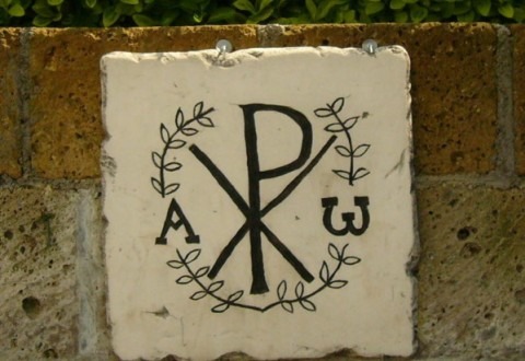 The Chi-Rho symbol, with the Greek letters Alpha and Omega represent the resurrection of Christ. Taken at the Park of Domicila catacomb in Rome, Italy. (Creative Commons)